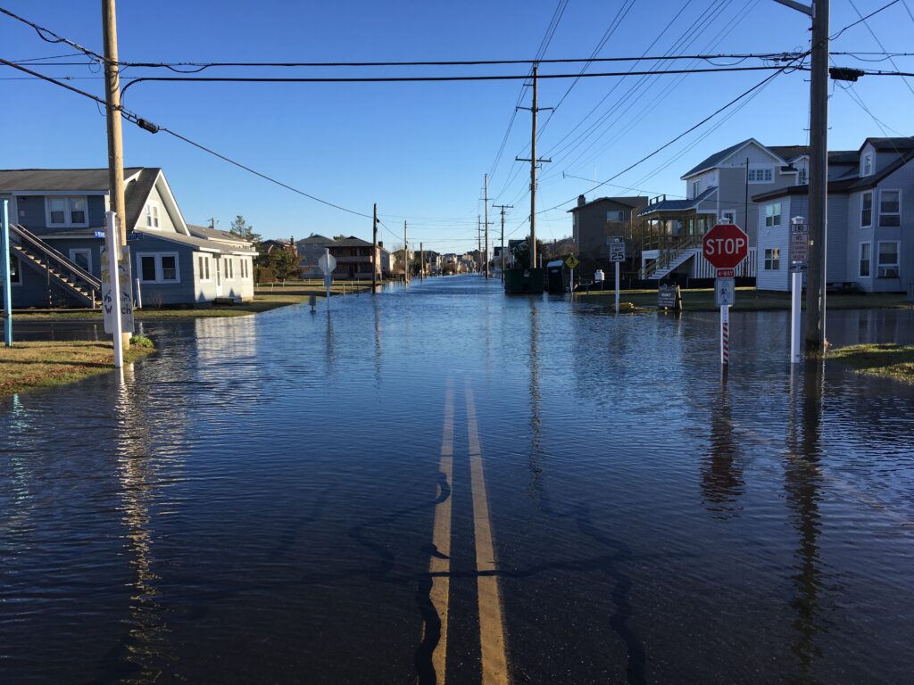 a flooded street with power lines above it